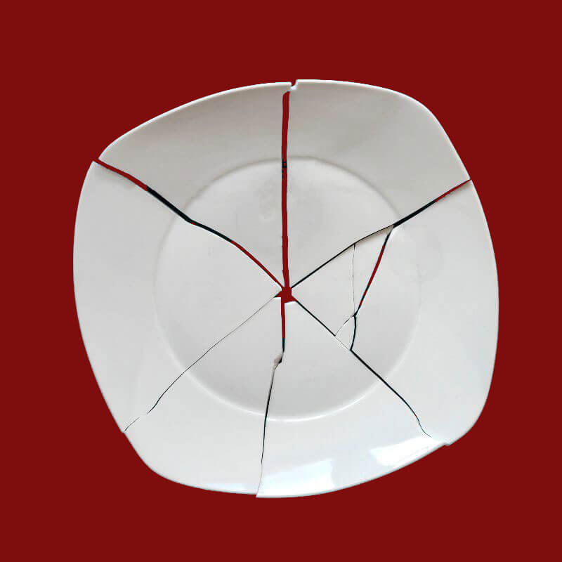 perfectly shattered white plate on red background